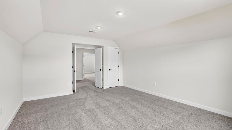 Bedroom with carpet and windows.