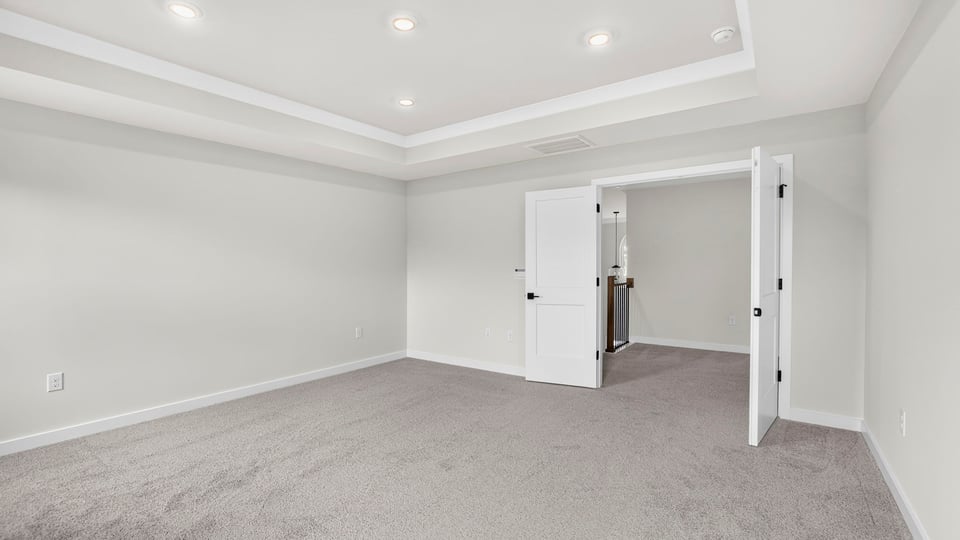 Bedroom with carpet and windows.