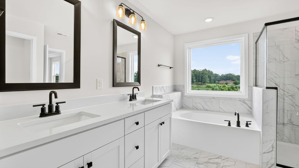 Bathroom with double vanity sink and window.
