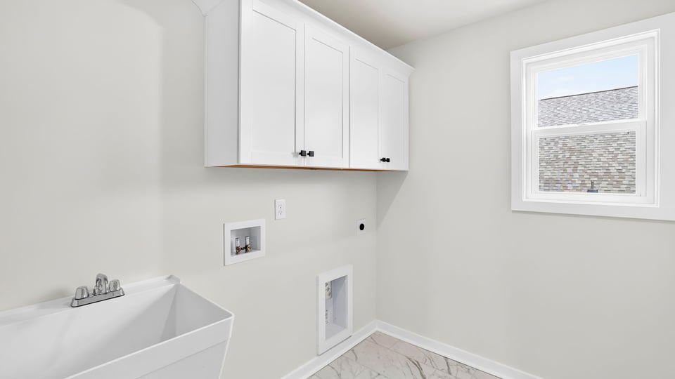Laundry room with hanging storage racks.