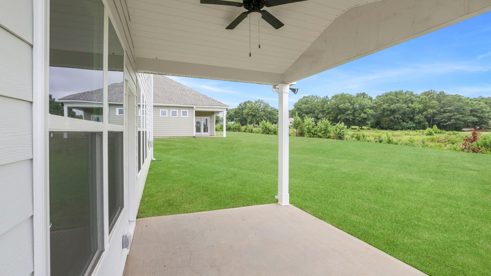 Back exterior of home with patio.