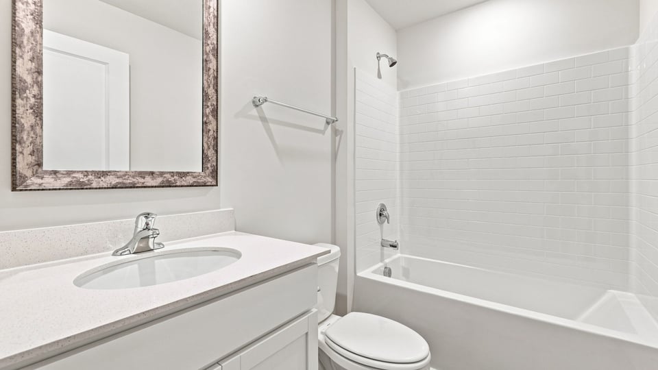 Bathroom with single vanity sink and bathtub.