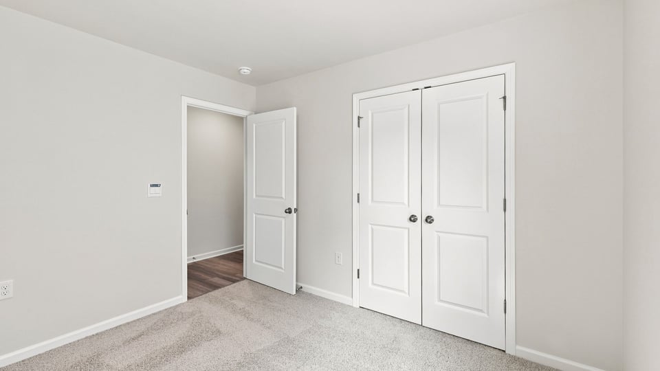 Bedroom with carpet and window.