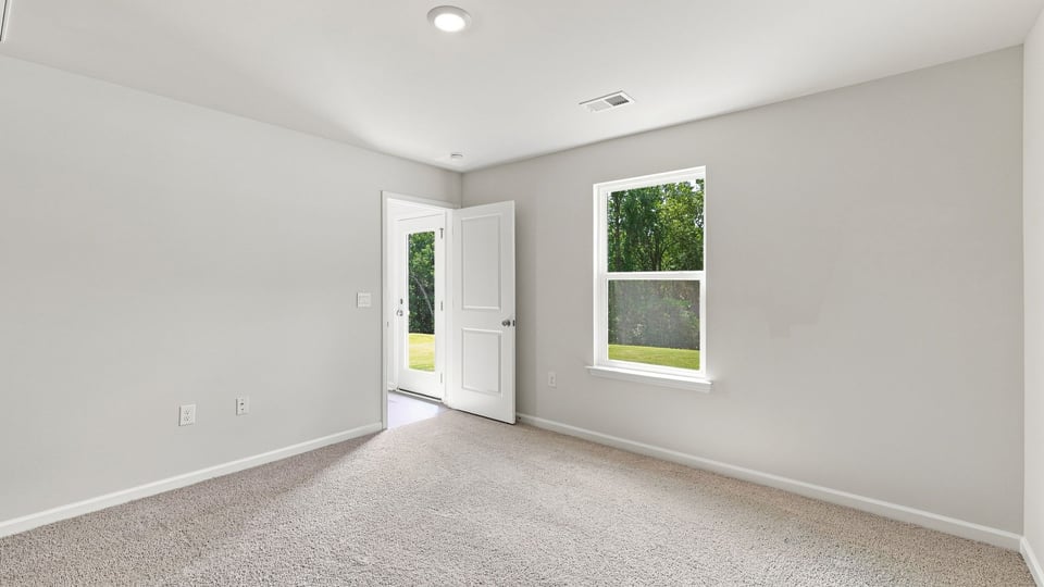 Bedroom with carpet and window.