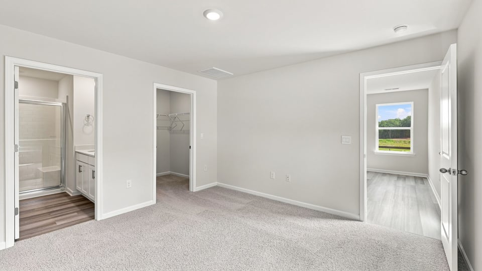 Bedroom with carpet and window.