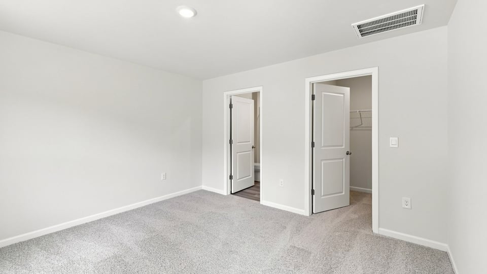 Bedroom with carpet and window.