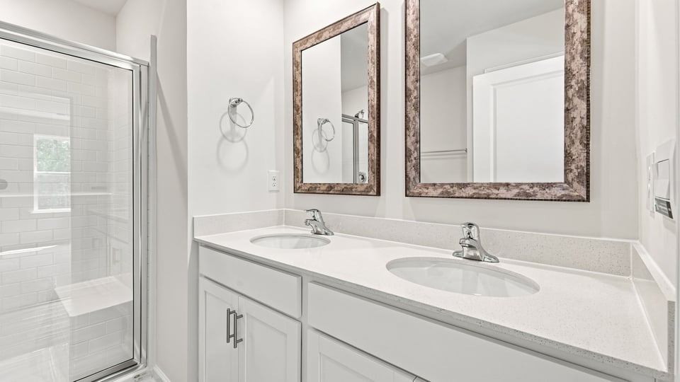 Bathroom with double vanity sink and bathtub.