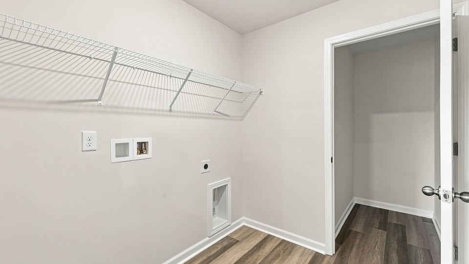 Laundry room with hanging storage racks.