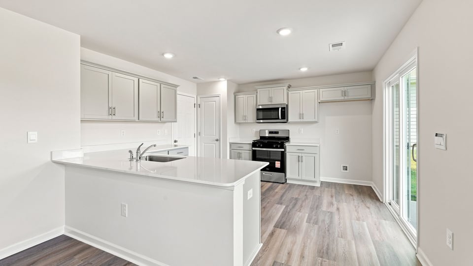 Kitchen and island with quartz countertops.
