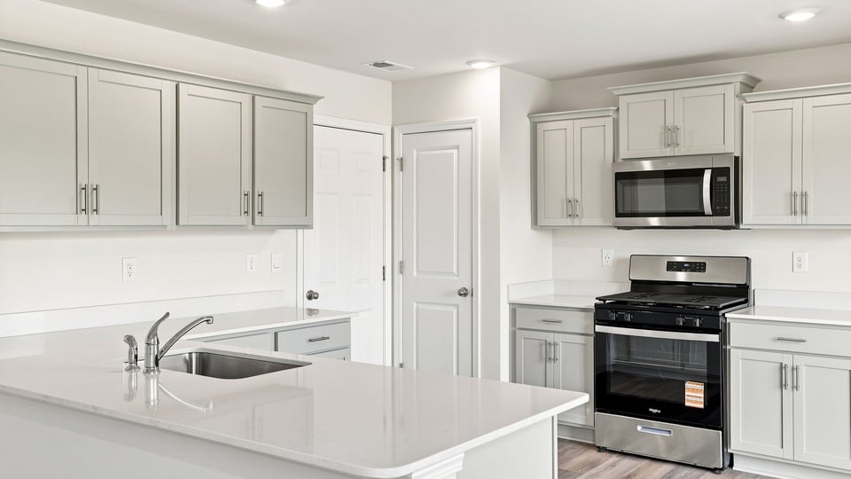 Kitchen and island with quartz countertops.