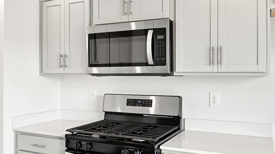 Kitchen and island with quartz countertops.