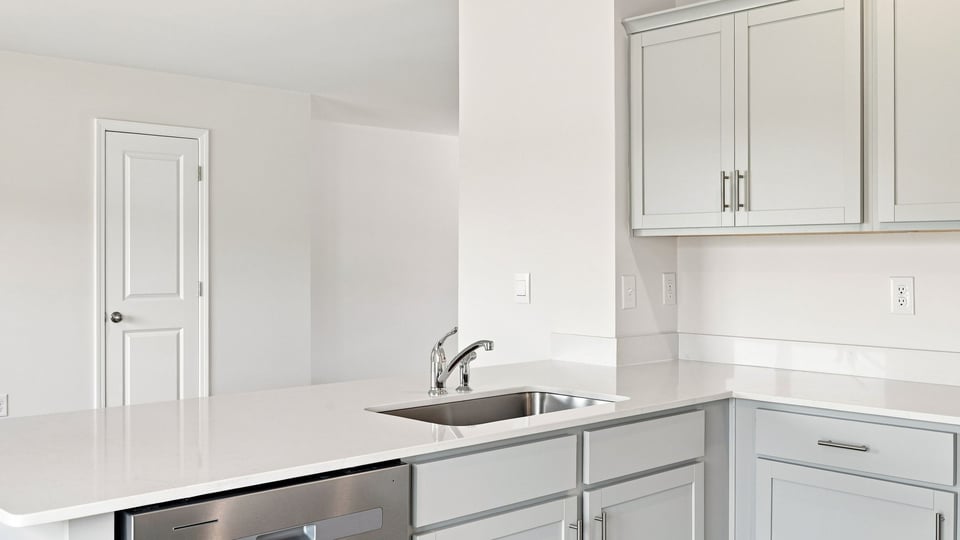 Kitchen and island with quartz countertops.