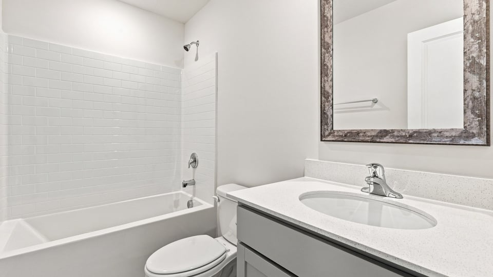 Bathroom with single vanity sink and bathtub.
