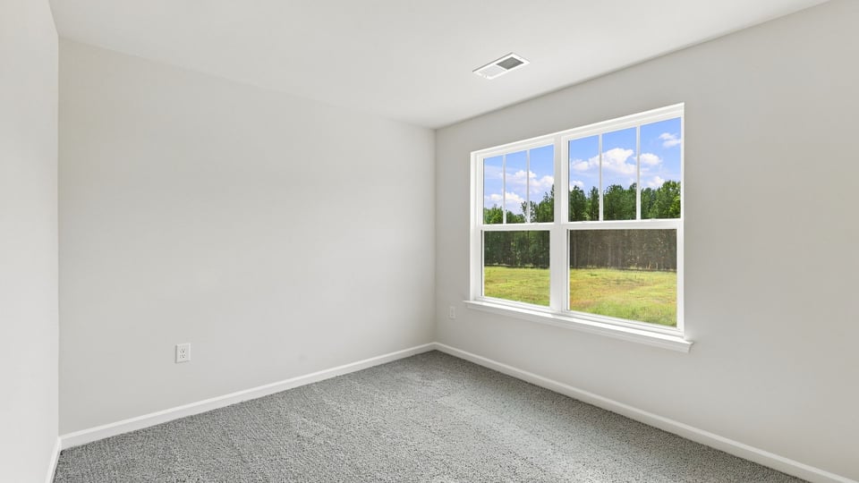 Bedroom with carpet and window.
