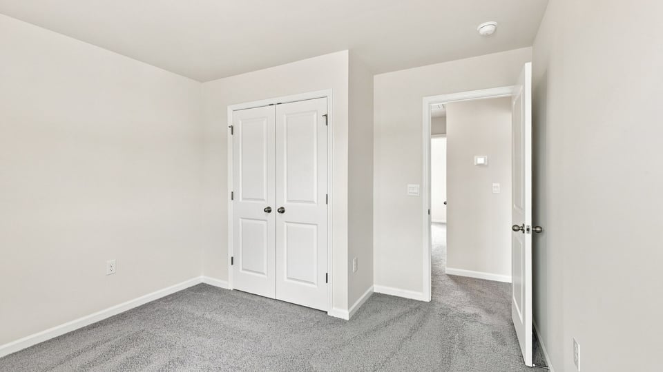Bedroom with carpet and window.