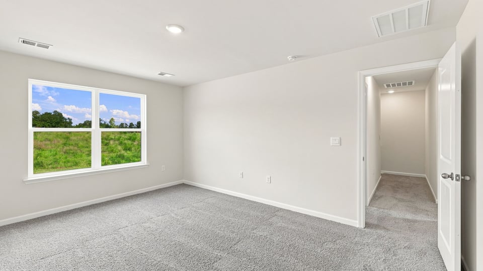 Bedroom with carpet and window.