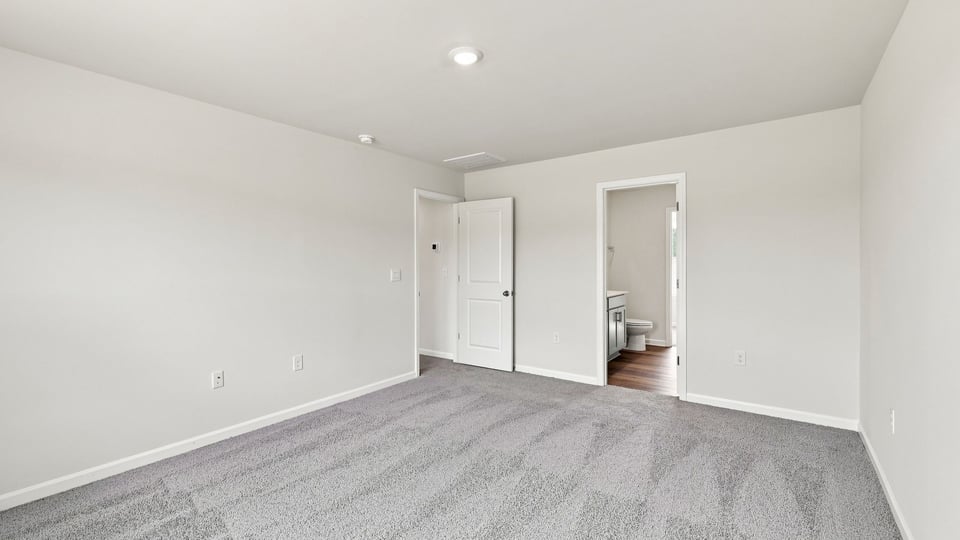Bedroom with carpet and window.