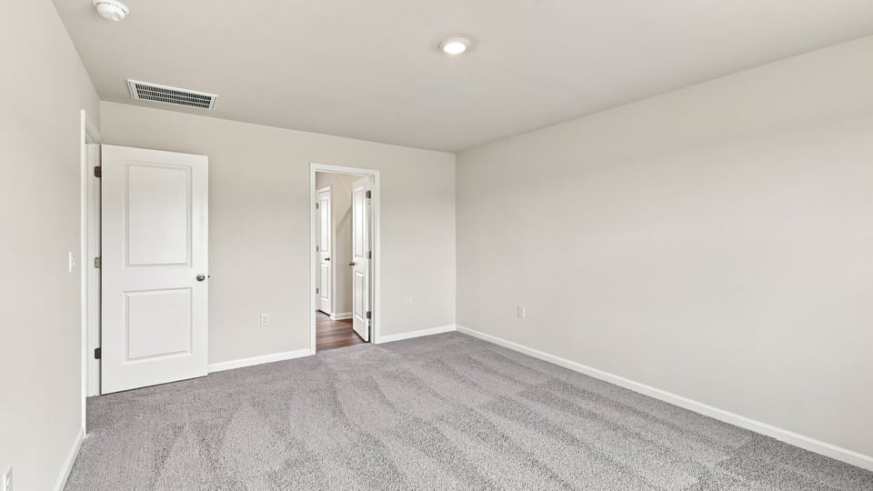 Bedroom with carpet and window.