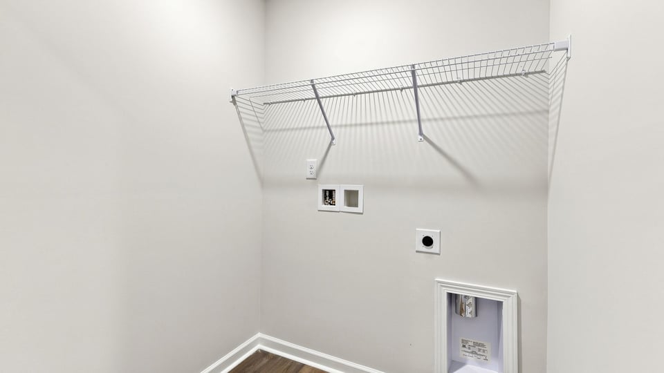 Laundry room with hangiing storage racks.