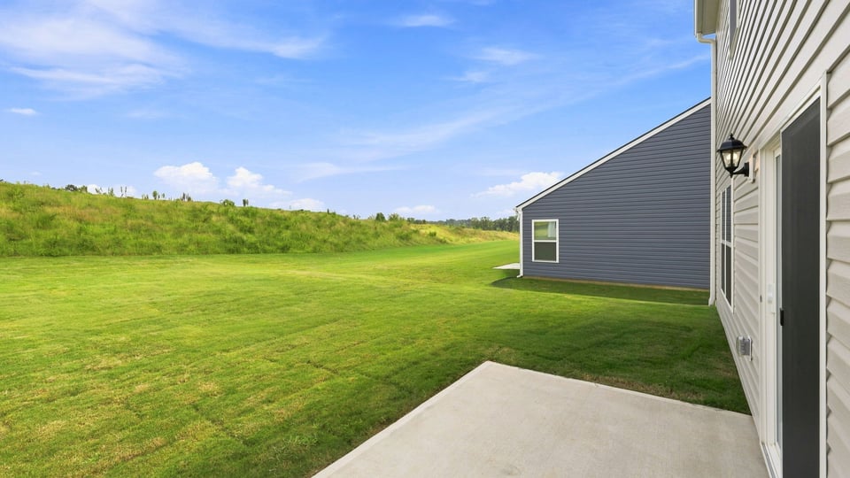 Back exterior of home with patio.