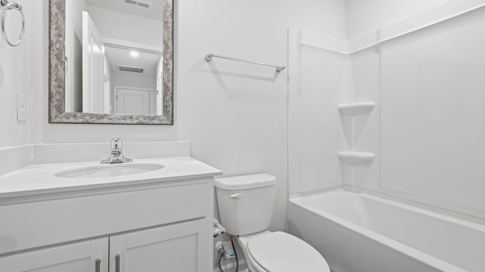 Bathroom with single vanity sink and bathtub.