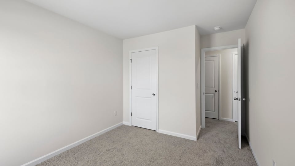 Bedroom with carpet and window.