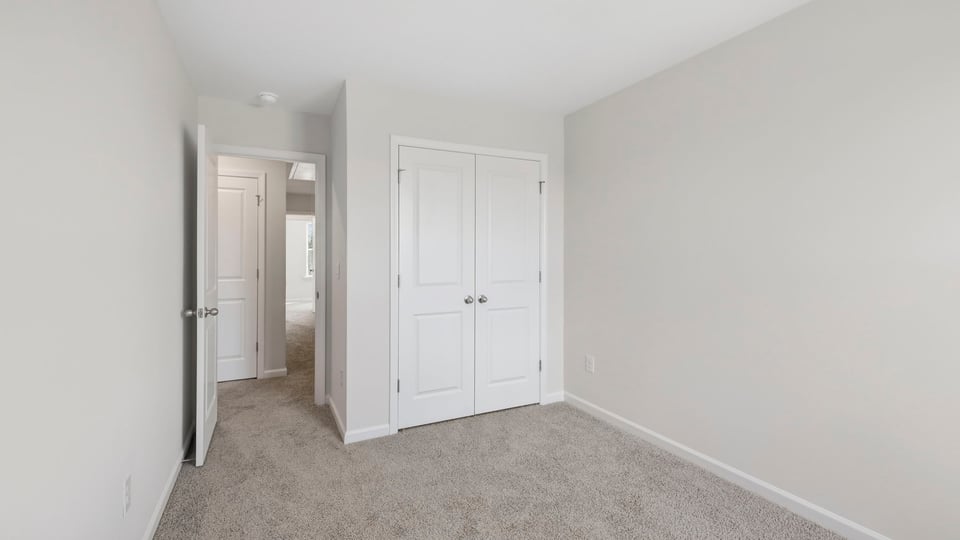 Bedroom with carpet and window.