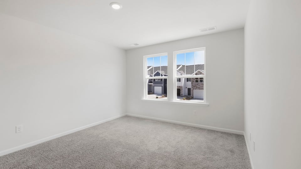 Bedroom with carpet and window.
