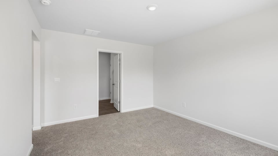 Bedroom with carpet and window.