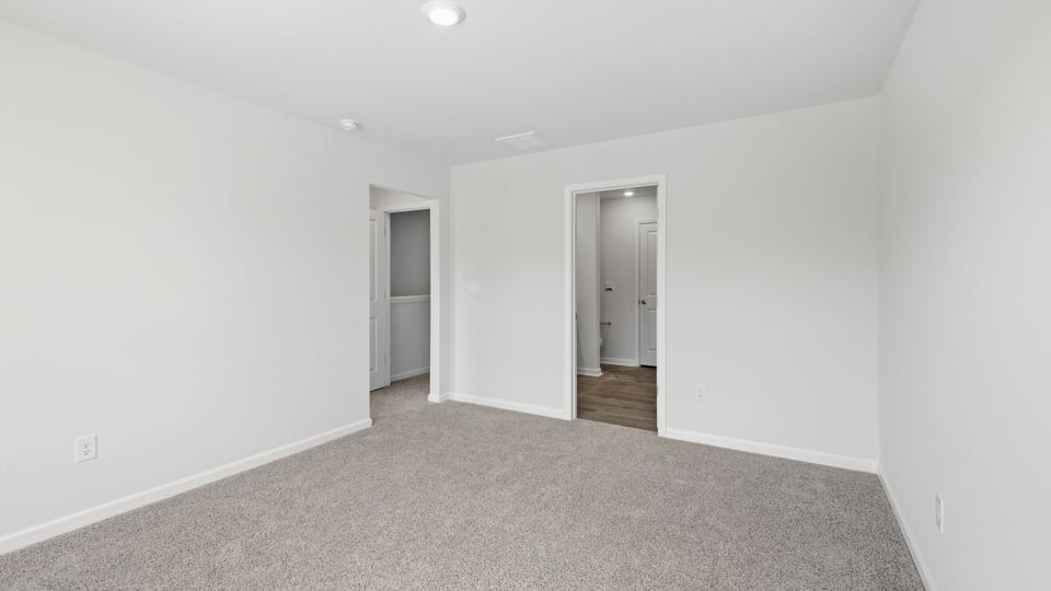 Bedroom with carpet and window.