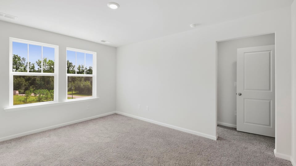 Bedroom with carpet and window.