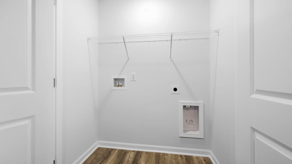 Laundry room with hanging storage racks.