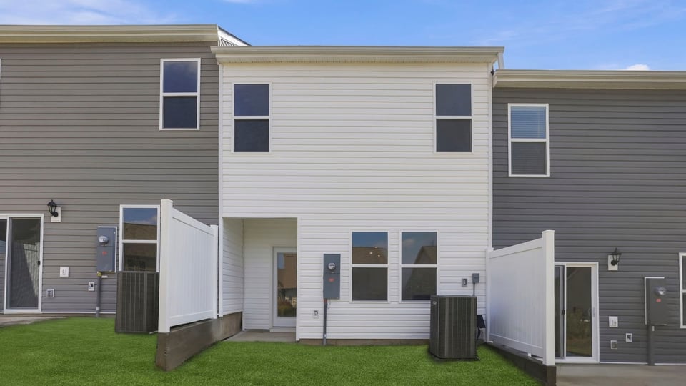 Back exterior of home with large backyard.