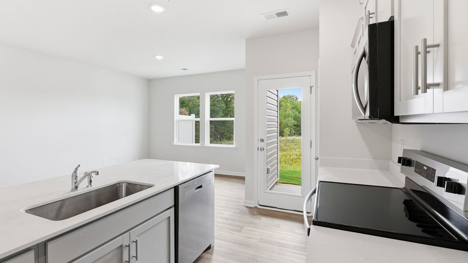 Kitchen and island with quartz countertops.