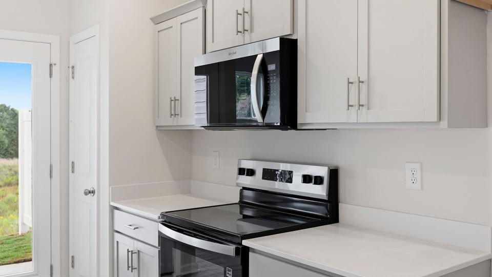 Kitchen and island with quartz countertops.