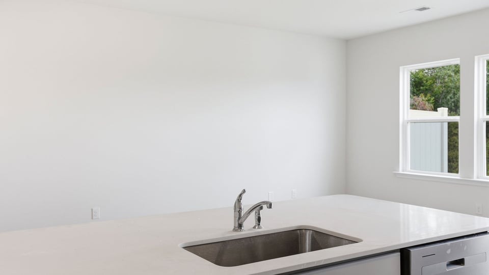 Kitchen and island with quartz countertops.