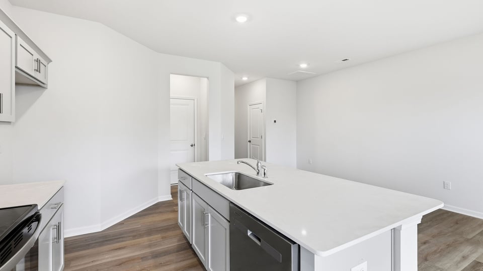 Kitchen and island with quartz countertops.