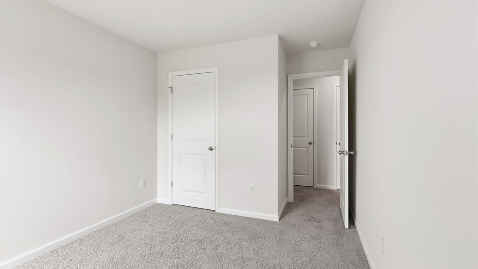 Bedroom with carpet and window.