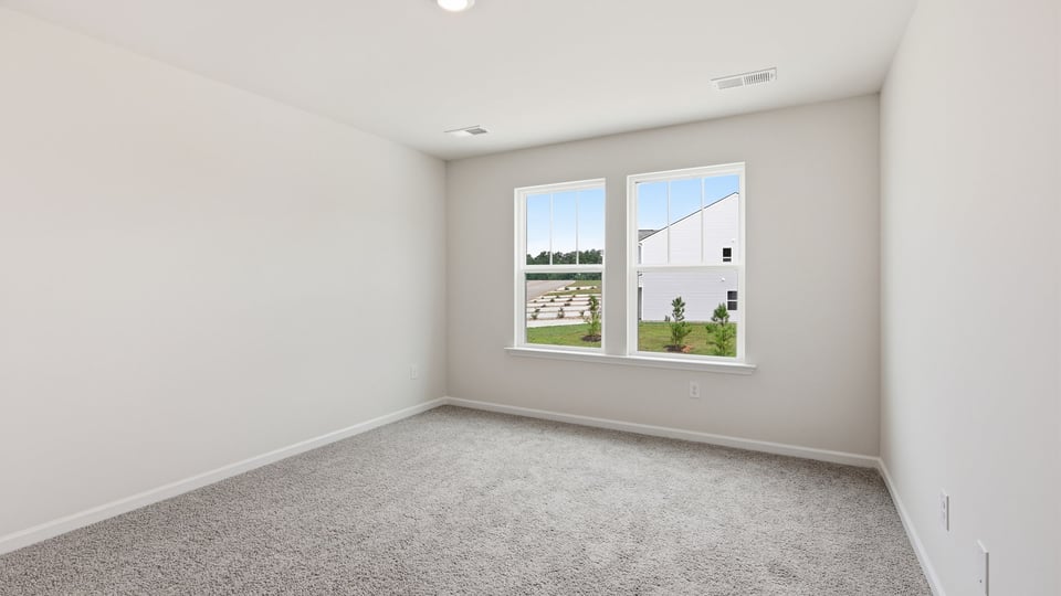 Bedroom with carpet and window.