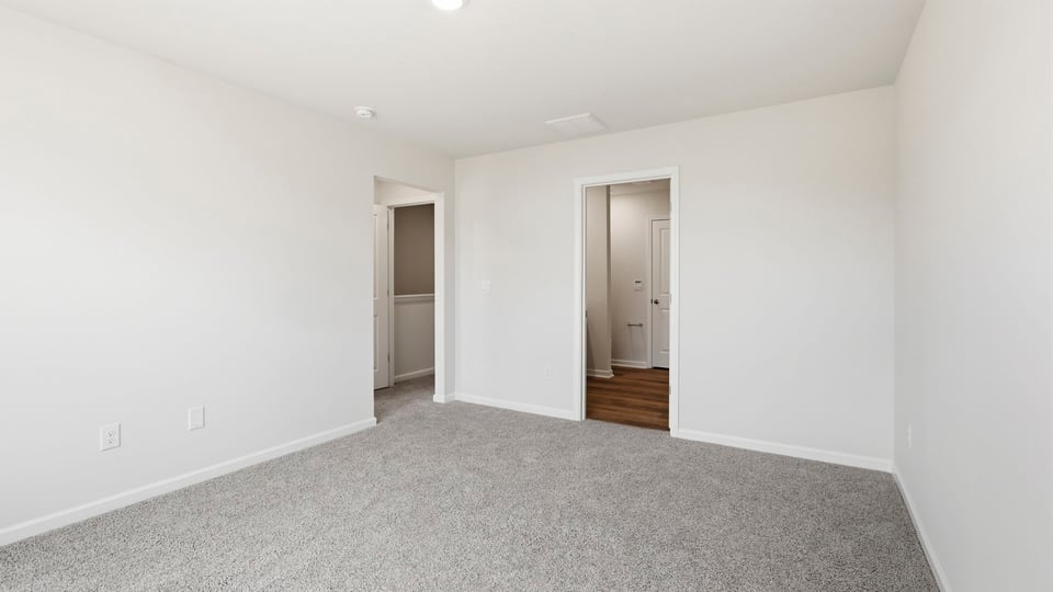 Bedroom with carpet and window.