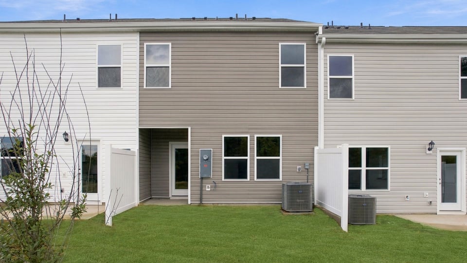 Back exterior of home with large backyard.