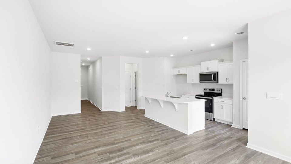 Kitchen and island with quartz countertops.