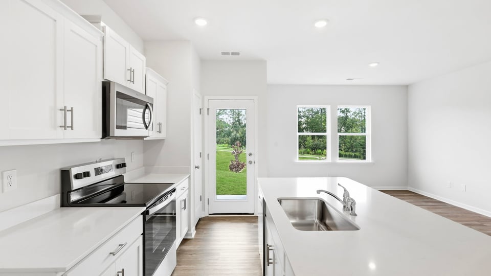 Kitchen and island with quartz countertops.
