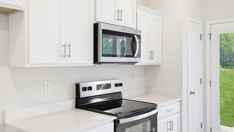 Kitchen and island with quartz countertops.