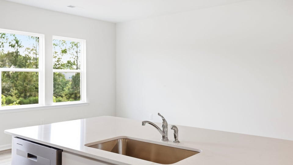 Kitchen and island with quartz countertops.