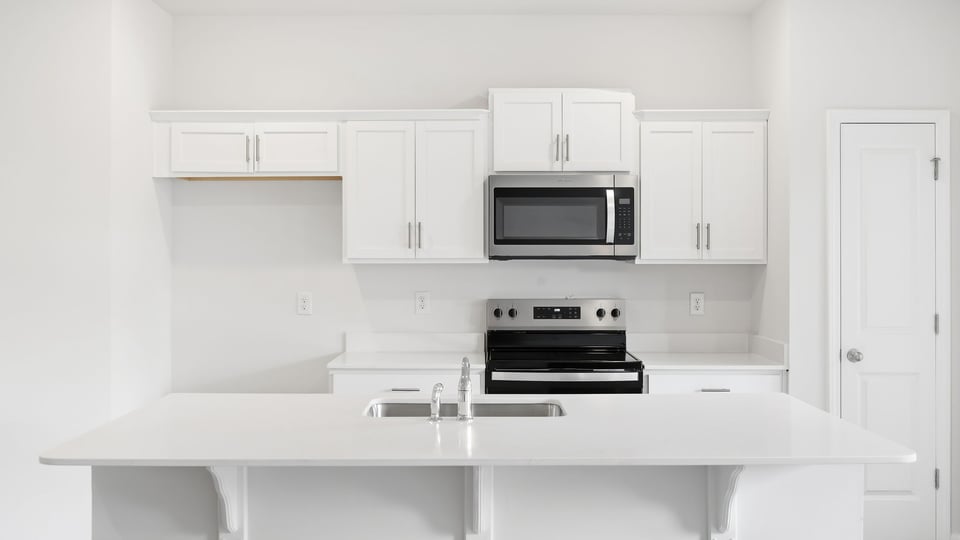 Kitchen and island with quartz countertops.