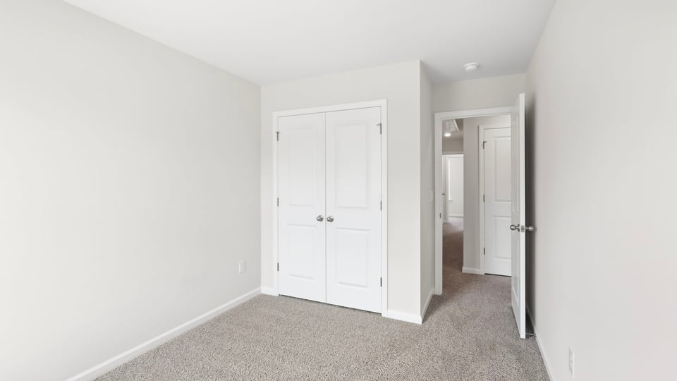 Bedroom with carpet and window.