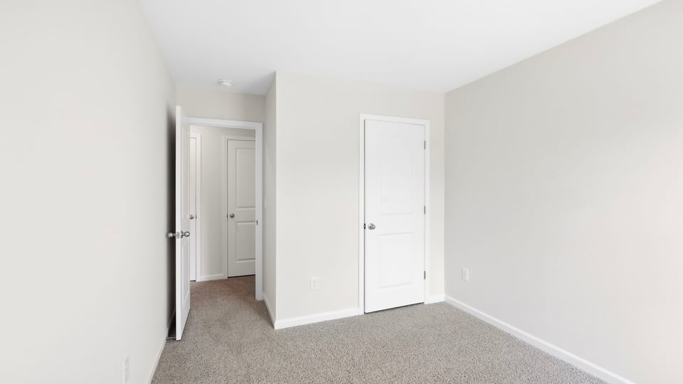Bedroom with carpet and window.