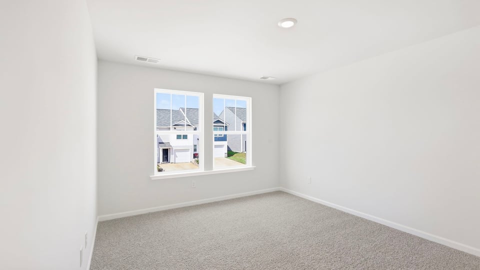 Bedroom with carpet and window.
