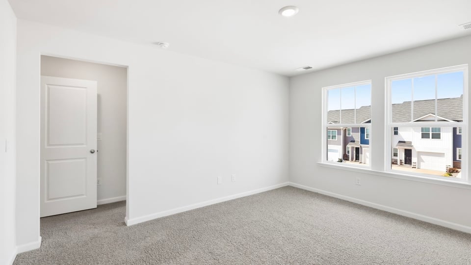 Bedroom with carpet and window.